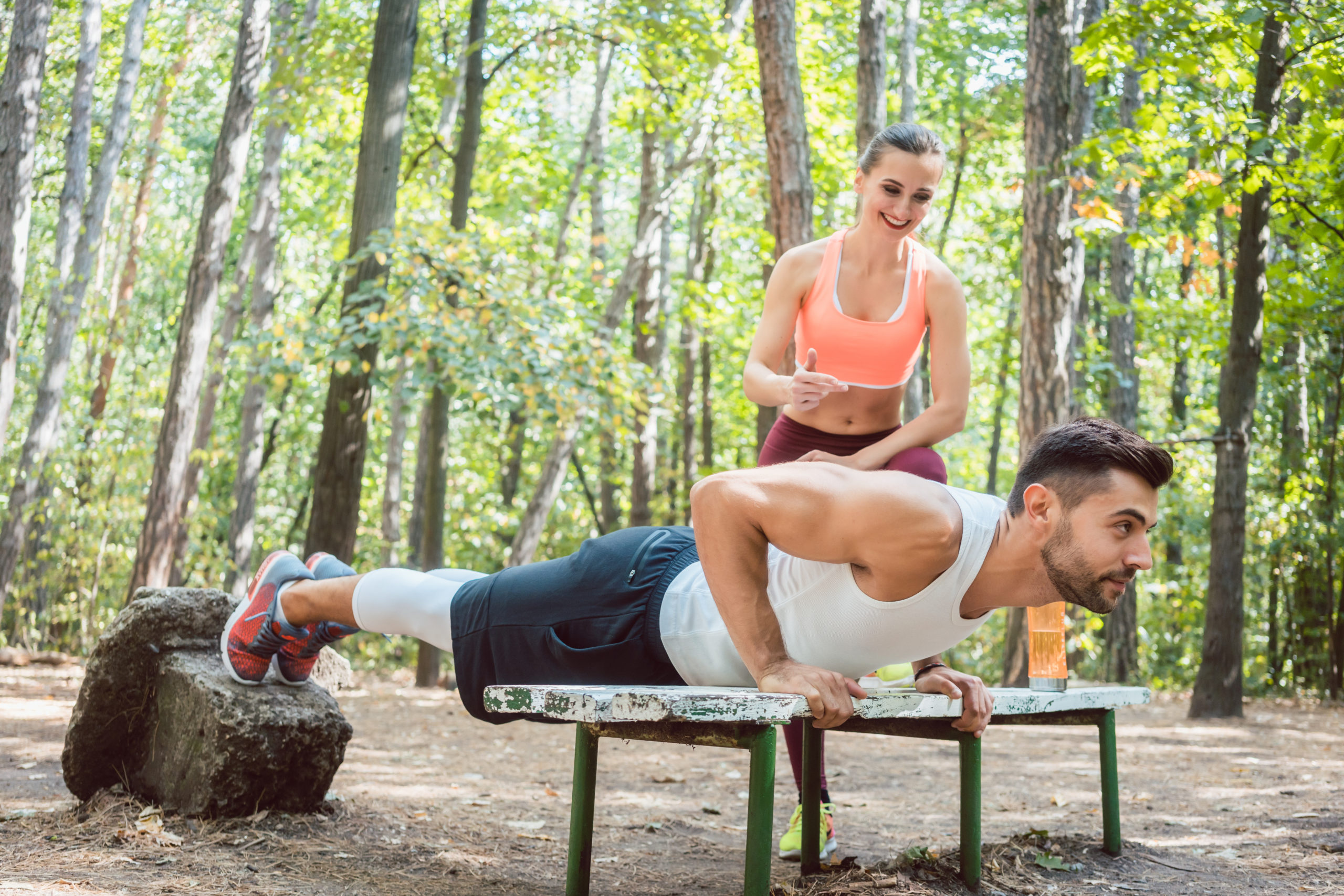 Sporty man doing push-up in an outdoor gym